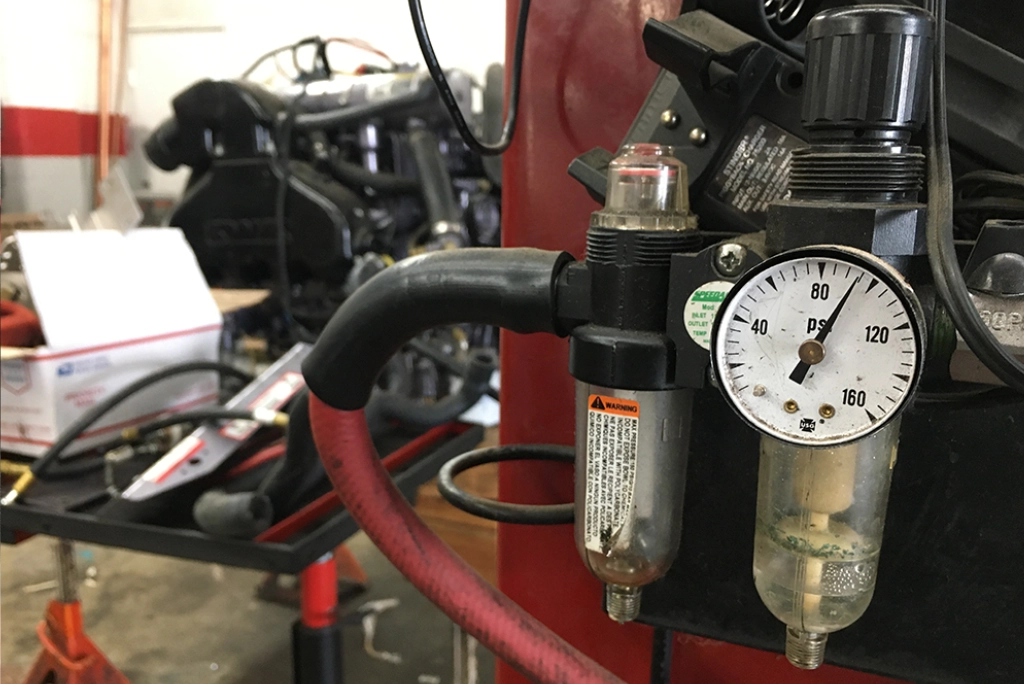 Close-up of a pressure gauge and diagnostic equipment used for EVAP system leak testing and DEQ emissions repair at Uncle Al's Auto Repair.