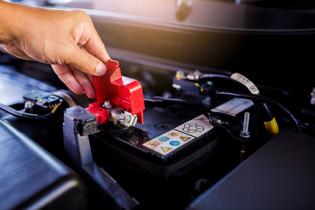 Closeup of one of Uncle Al's ASE certified automotive technician working on a local Oregon residents car battery.