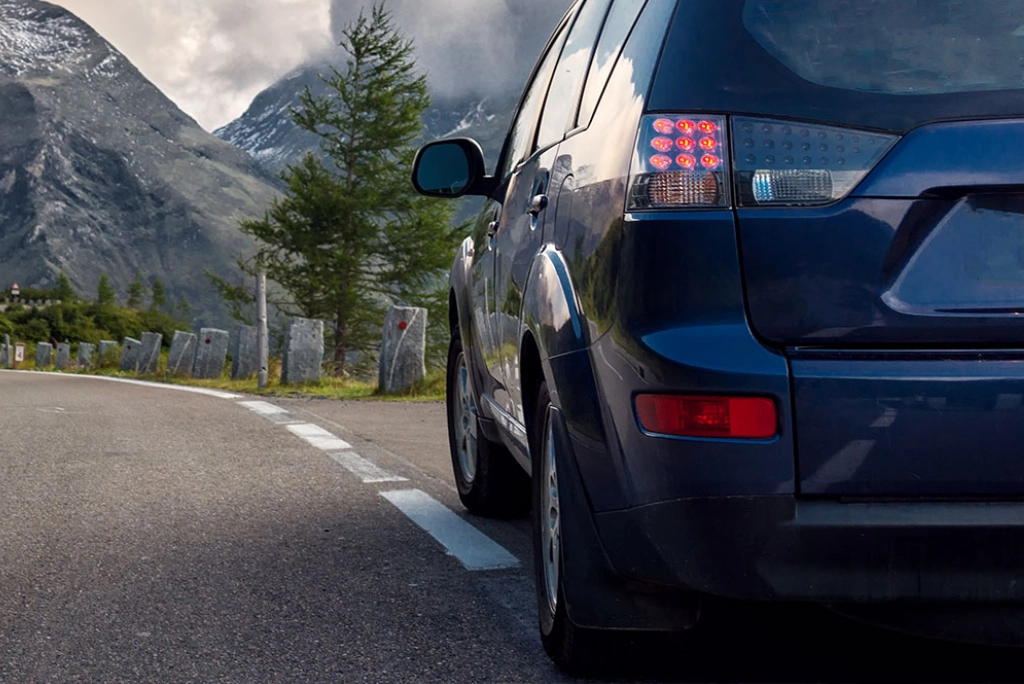 Closeup from behind an Uncle Al repaired vehicle as it drives across the outdoors of Gladstone Oregon.