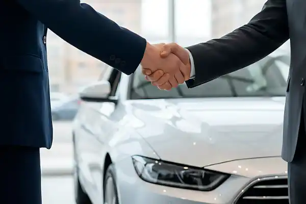 Two men shaking hands after the purchase of a new car, ready for Uncle Al's Pre Purchase Inspections.