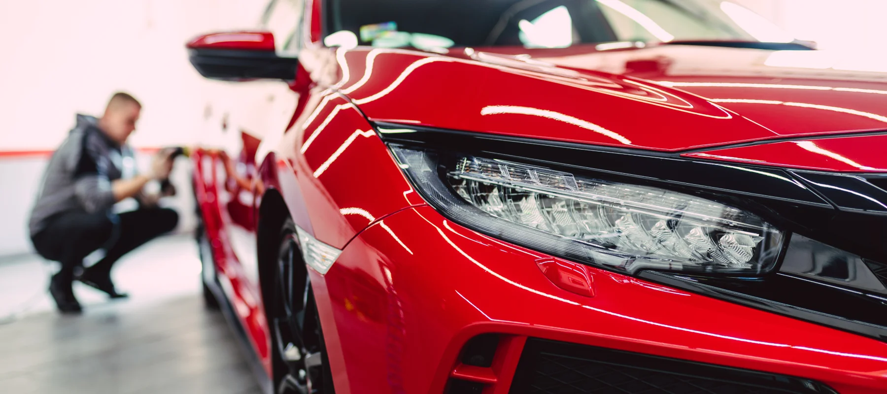 Closeup of a sleek red car inside of Uncle Al's auto repair workshop, local to Gladstone OR residents.