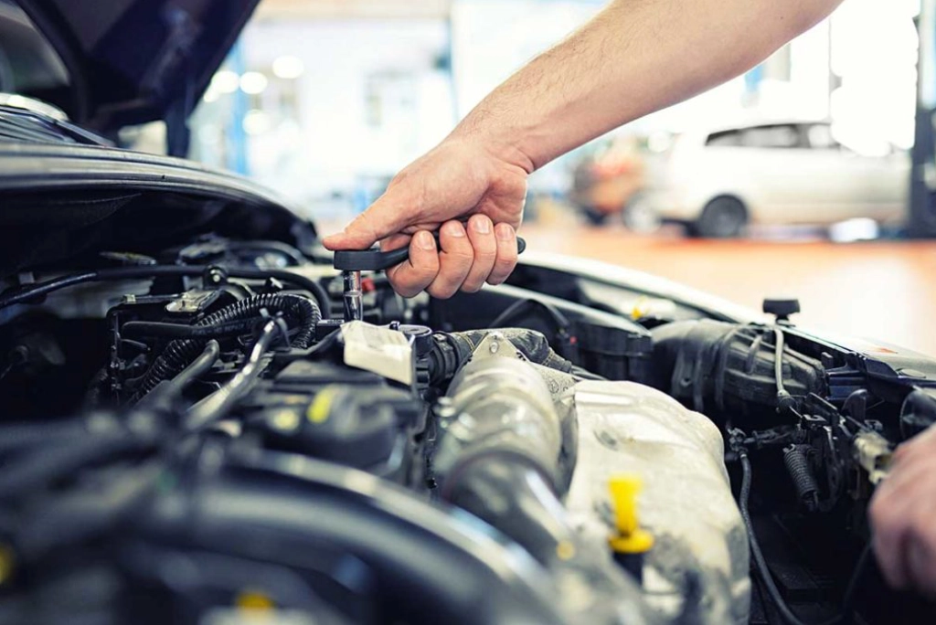 Closeup of one of Uncle Al's ASE certified automotive technician working under the hood of a local residents vehicle.