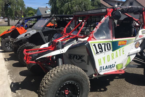 Photo of a a row of several Yamaha YXZ four wheelers lined up outside Uncle Als.