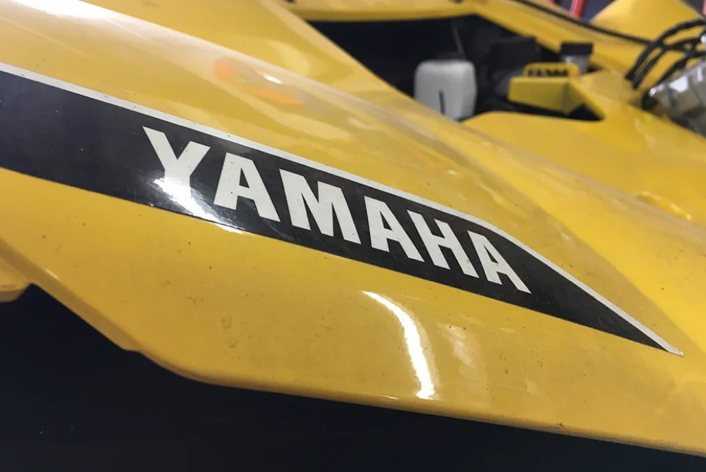 Closeup of the Yamaha logo on a yellow YXZ four wheeler.