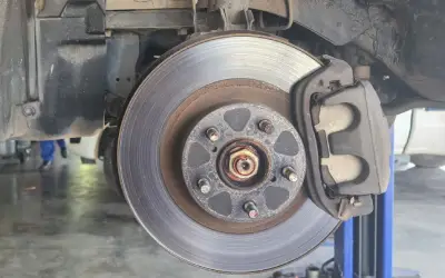 car in auto mechanic shop for disc brake repair