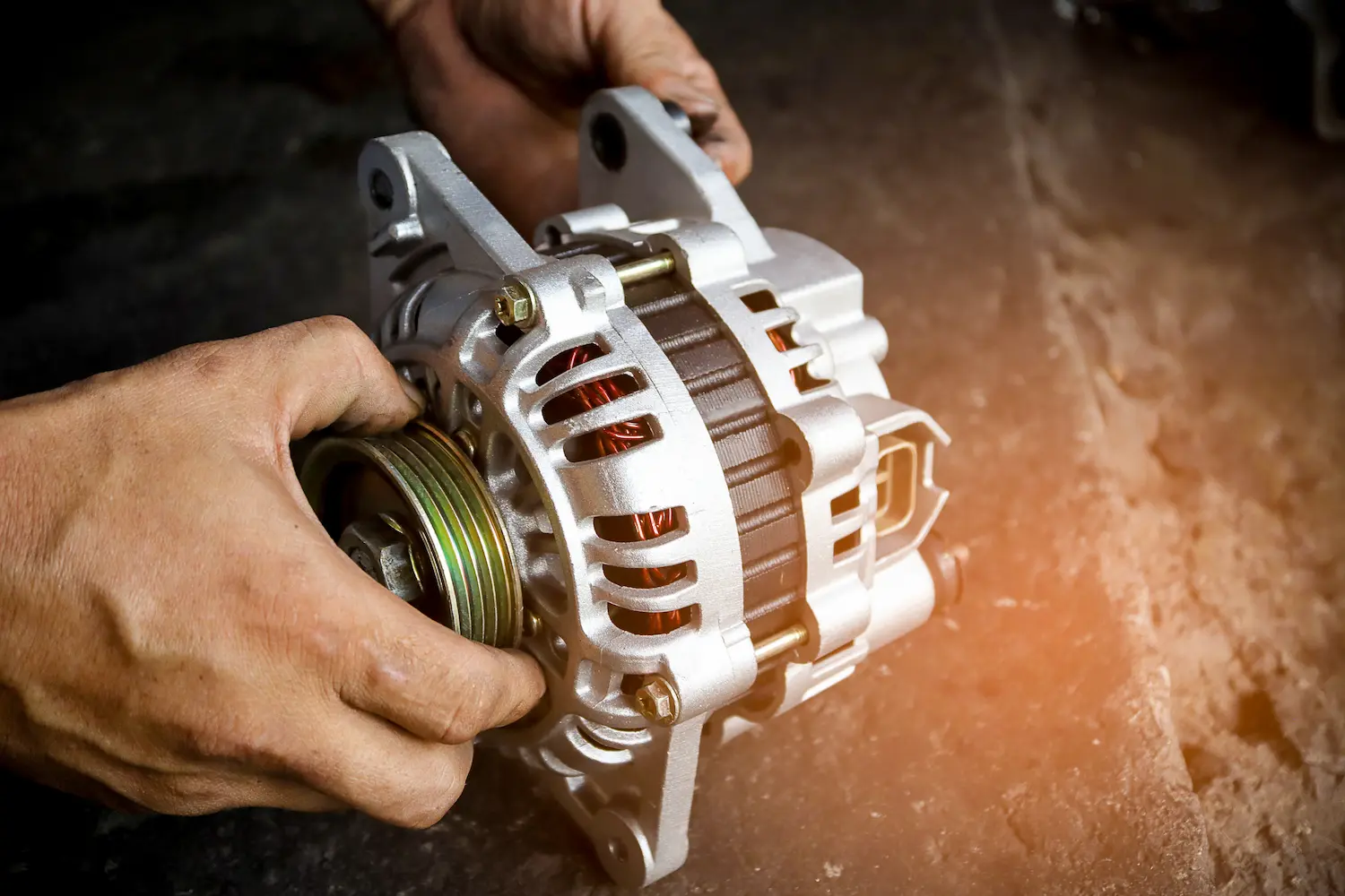 Uncle Al's mechanic holding an alternator