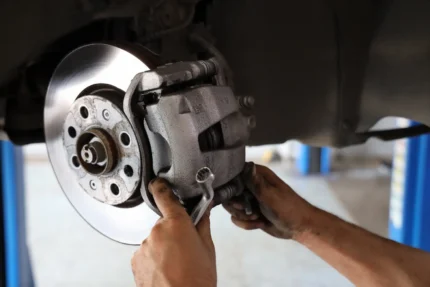 Uncle Al's mechanic repairing a car brake